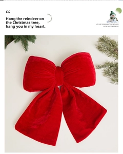 Detail of red velvet Christmas bow decoration with green pine branches for tree decor