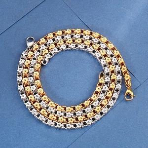 Two-tone gold and silver stainless steel necklace with floral chain links and lobster clasp