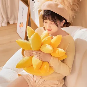 Soft sunflower plush throw pillow in bright yellow held by a person in a cozy setting