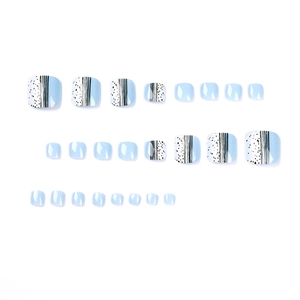 Sky blue and white press-on toenails with polka dots and stripe designs on white background