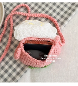 Detail view of the handmade crochet mini bag showing interior space for a phone