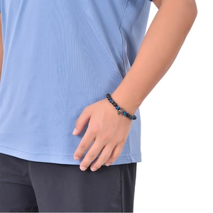 Men's 8mm blue tiger eye and matte stone bracelet featuring a silver metal skull charm