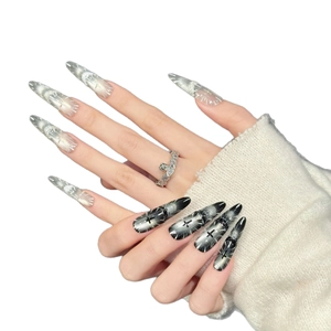 Handmade stiletto press-on nails in gothic black gradient and iridescent white with glitter
