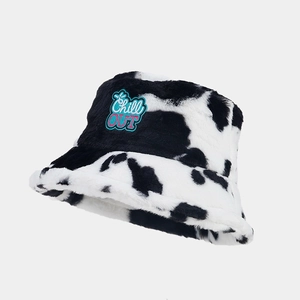 Detail of plush cow print bucket hat with Chill OUT colorful embroidered letter patch