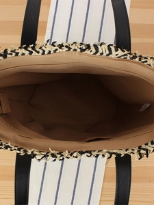 Top view of woven tote bag with brown lining, inner pocket and black-white fringe details