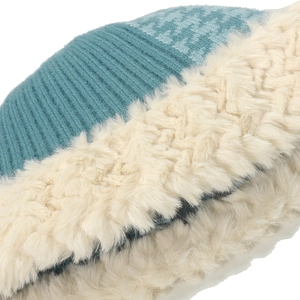 Close-up of winter bucket hat showing houndstooth knit and faux fur texture details
