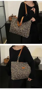 Detailed shot of leopard print tote bag with brown leather straps and gold chain accents