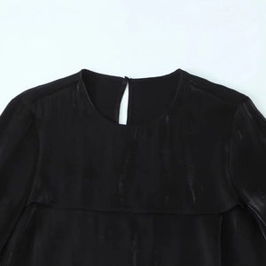 Satin shirt with round neck and back opening in black pleated fabric texture