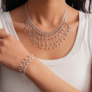 Chic silver beaded tassel necklace and bracelet set shown on model for women