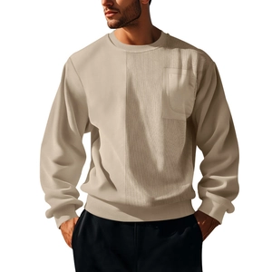 Detail shot of men's beige corduroy crewneck sweatshirt featuring a chest pocket and ribbed texture