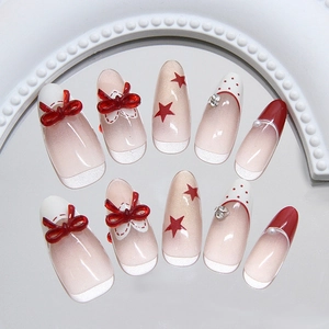 Red bowknot press-on nails with polka dots, sparkling rhinestones and star designs