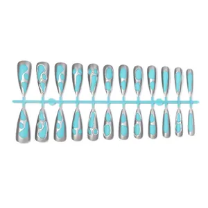 Long stiletto press-on nails with 3D silver metallic borders and blue drip patterns