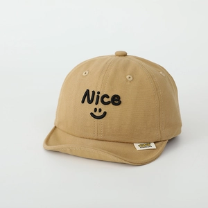 Close-up of khaki cotton baby cap with smile embroidery and short soft brim details