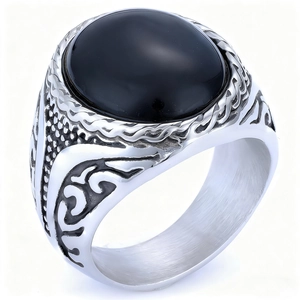 Macro shot of vintage silver ring with black agate stone and intricate vine engraving