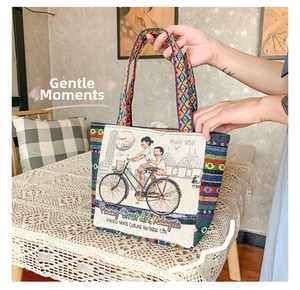 Detailed close-up of woven ethnic tote bag featuring Penang Street Art bicycle mural design