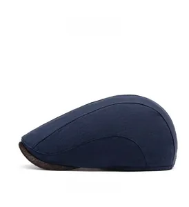 Detail of navy cotton-linen flat cap with side stitching and brown leather brim trim
