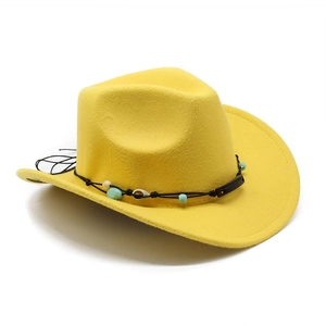 Detail of bright yellow felt cowboy hat with shell accent and beaded black rope band