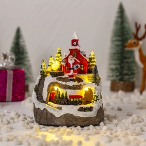 Close-up of a festive Christmas village with Santa, moving train, and warm LED lights