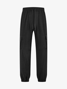 Macro shot of men's casual cargo pants featuring elastic drawstring waist and textured fabric