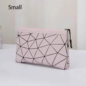 Close-up of pink geometric makeup bag featuring black triangular patterns and smooth zipper