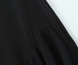 Macro shot of black chiffon dress stitching with smooth fabric and mesh texture detail