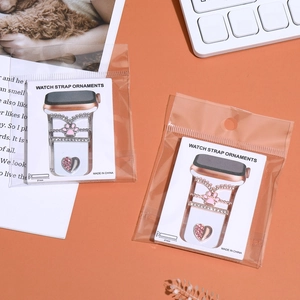 Detailed view of silver and rose gold charms for Apple Watch silicone bands