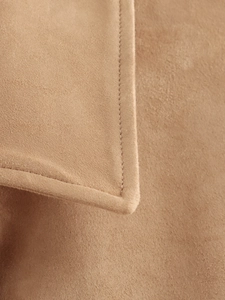 Detail of soft camel suede jacket showing high-quality stitching and collar texture