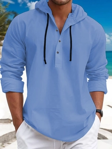 Detail of light blue waffle knit hoodie with black drawstrings and three buttons