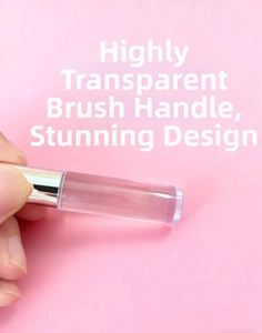 Detail of high transparency brush handle with silver metal ferrule held by hand
