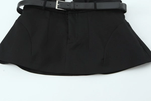 Detail of black halter top featuring a faux leather belt and smooth woven fabric texture