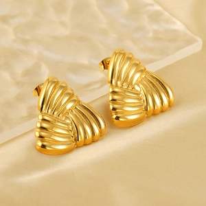 Macro shot of 18k gold plated stainless steel stud earrings with unique textured patterns