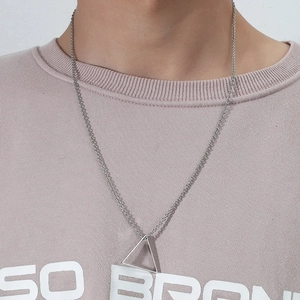 Polished stainless steel necklace with minimalist triangle pendant worn by a male model