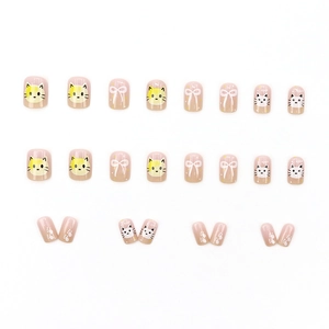 Short square pink cat press-on nails with bow and paw print designs on white background