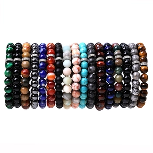Detailed macro view of assorted natural tiger eye and agate beaded bracelets with metal spacers