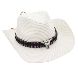 Detail of white straw cowboy hat featuring ethnic band and silver bull skull ornament