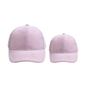 Detail of pink corduroy baseball caps in parent-child set showing striped texture