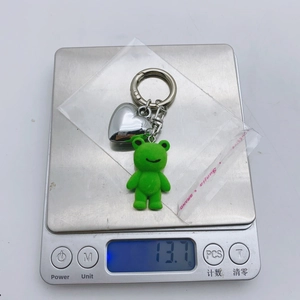 Weight measurement of 13.7g for the green flocked bear charm with silver heart