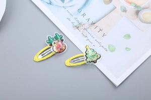 Detail of Christmas BB hair clips featuring reindeer and glittery tree designs