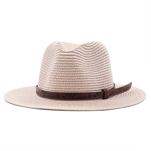 Classic straw cowboy hat with a bohemian floral leather band on a white background