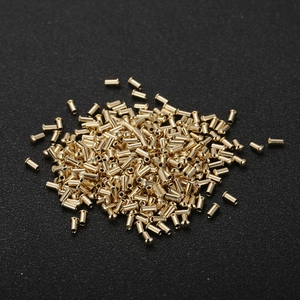 Pile of precision stainless steel cylindrical metal hardware parts in gold finish
