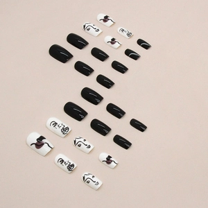 Minimalist black and white press-on nails with artistic abstract face line patterns