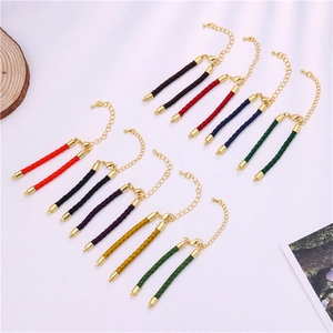 Detail of multi-color braided rope bracelets with gold lobster clasps and extension chains