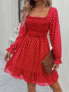Detail of square neckline with smocked chest on red polka dot long sleeve dress