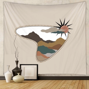 Detailed view of bohemian tapestry with sun and mountains on minimalist wall decor