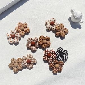 Padded fabric flower accessories with plaid, polka dot and houndstooth patterns