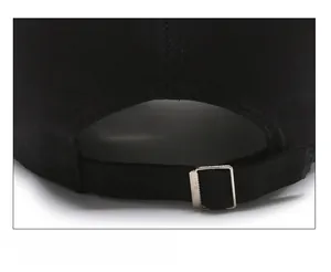 Detail shot of black cotton baseball cap with adjustable silver metal buckle at the back