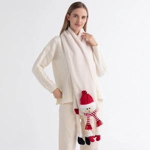 Detail of knit scarf with cute snowman doll decoration for winter Christmas outfit