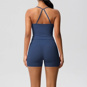 Detail of cross-strap back design on a navy blue athletic yoga jumpsuit for women