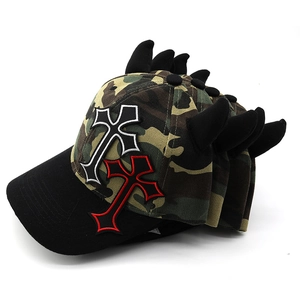 Detail view of the camouflage cap with black 3D horns and gothic cross embroidery