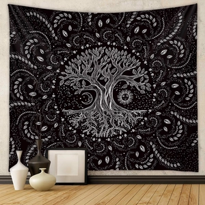 Detail of life tree tapestry hanging in a cozy room with sun and moon pattern